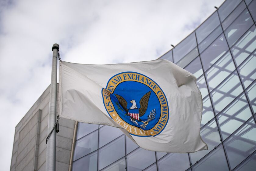 The Securities and Exchange Commission flag flies in front of a building.
