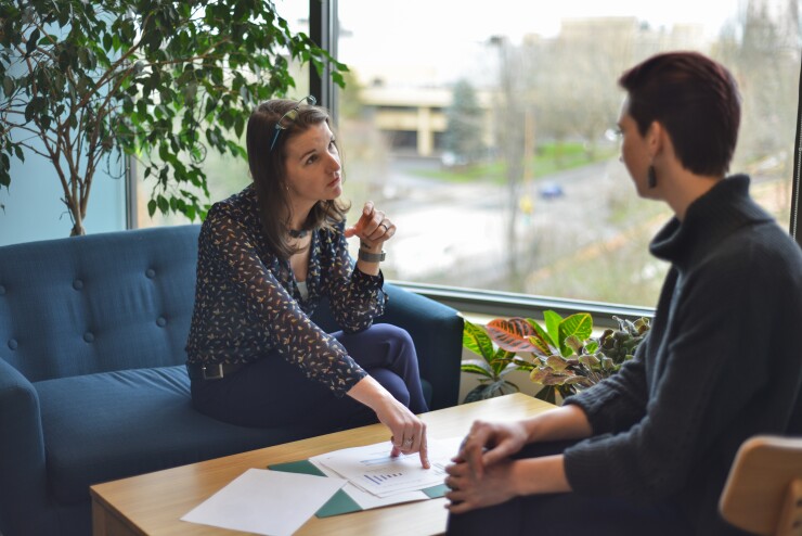 Advisor Brenna Baucum poses for a photo in the offices of the H Group in Salem, Oregon