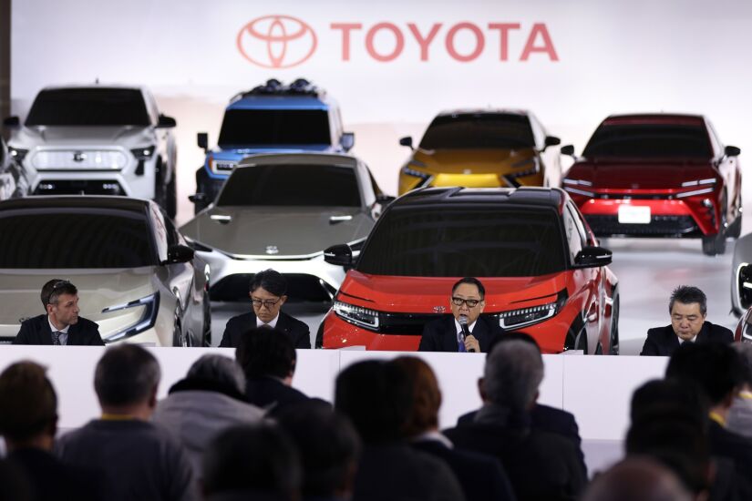 Akio Toyoda, president of Toyota Motor Corp., second right, speaks while Simon Humphries, head of Toyota and Lexus Global Design, left, Koji Sato, chief branding officer of Toyota Motor Corp. and president of Lexus International Co., second left, and Masahiko Maeda, chief technology officer of Toyota Motor Corp., listen during a news conference at the company's showroom in Tokyo, Japan, on Tuesday, Dec. 14, 2021. The world’s biggest carmaker is planning to invest 4 trillion yen ($35.2 billion) to supercharge its EV push, with a target to sell 3.5 million units annually by the end of the decade, according to Toyoda. Toyota will roll out 30 electric models by 2030, a step up from a prior plan to introduce 15 EVs globally by 2025. Photographer: Kiyoshi Ota/Bloomberg