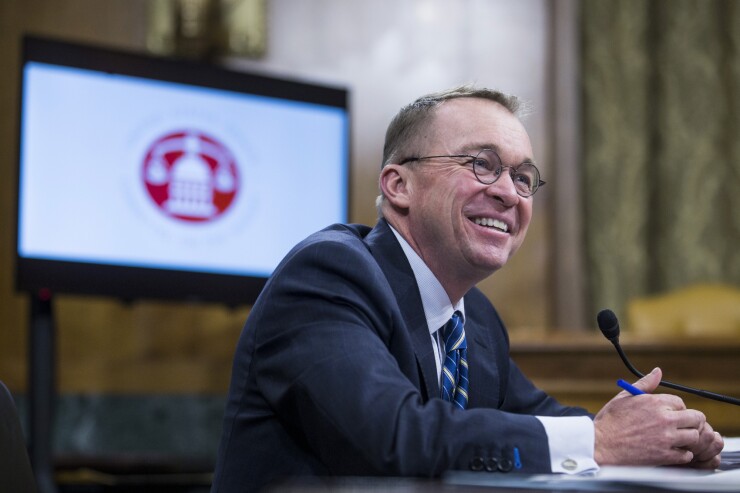 Mick Mulvaney, director of the Office of Management and Budget, smiles during a Senate Budget Committee hearing