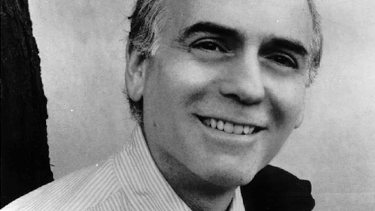 William Zimmerman, smiling with jacket held over shoulder. He was editor-in-chief of American Banker from 1980-1989.