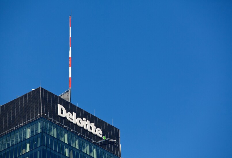 A logo sits above the head office of Deloitte LLP in Warsaw, Poland, on Monday, Jan. 9, 2017. Investors in Poland are betting that the nation’s central bank will raise its benchmark rate faster than stated. Photographer: Piotr Malecki/Bloomberg