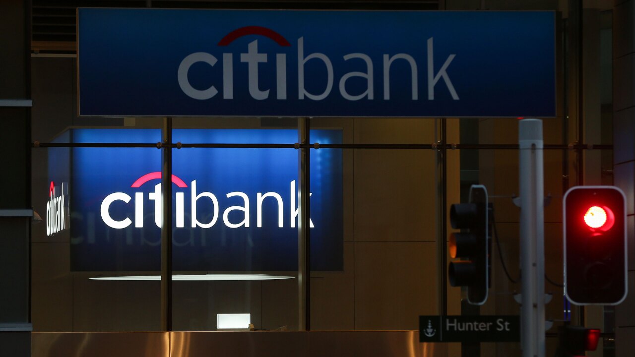 A traffic light stands in front of a Citibank branch in Sydney, Australia.