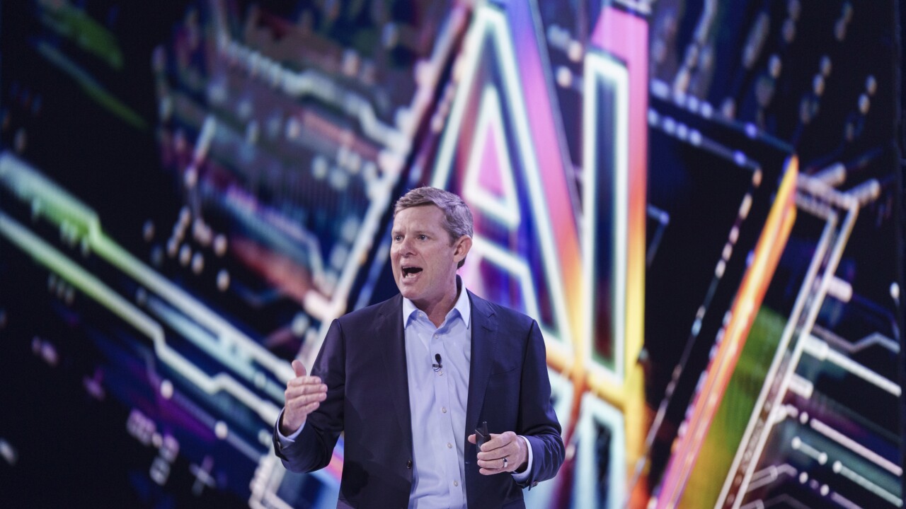 Ryan McInerney, Visa CEO, speaks in front of a multicolored screen backdrop.