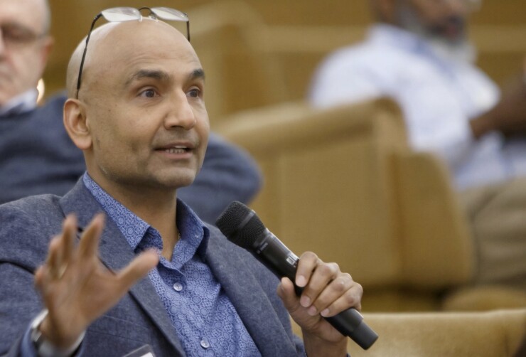 Surjit Chana holding a microphone