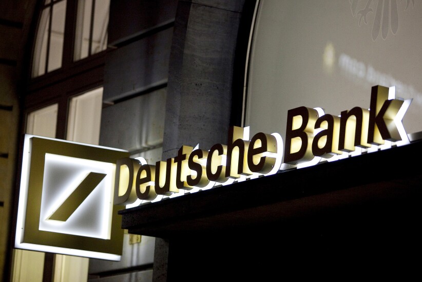 An illuminated sign for Deutsche Bank outside a bank branch in Frankfurt, Germany.