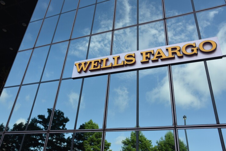 Wells Fargo shiny glass signage displayed on the exterior of a bank branch in Dallas on Monday, July 10, 2017 Bloomberg News