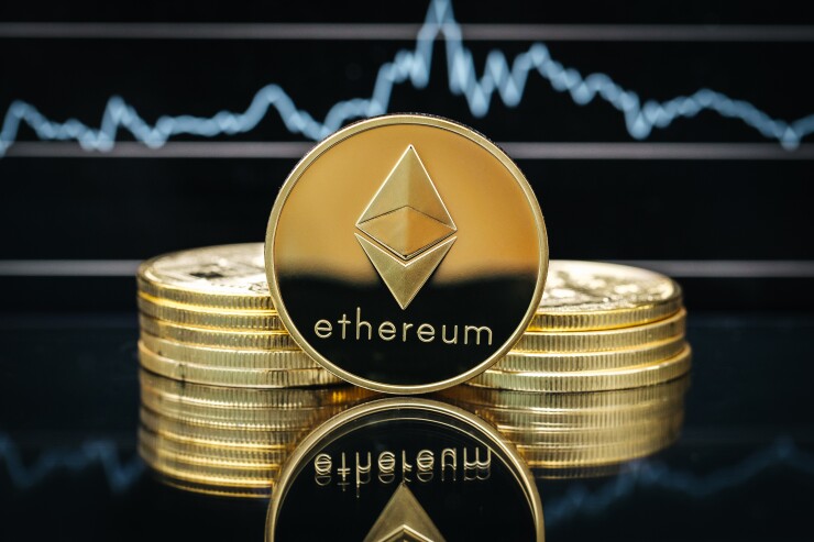 Ethereum cryptocurrency, physical coin close-up, in front of a price chart Ether ethereum digital asset crypto