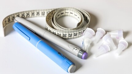 GLP-1 medication and a tape measure.