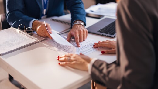 The real estate agent closes the deal with the client and they sign the contract.