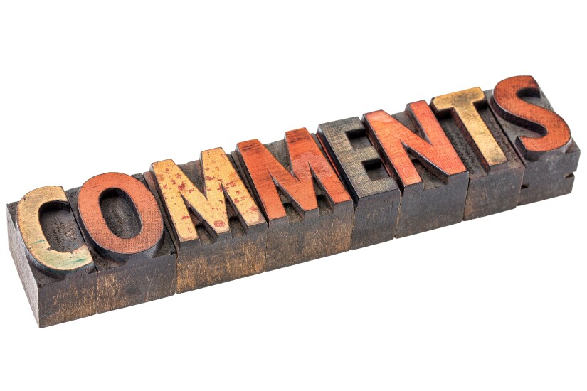 The word "comments" spelled with wooden block letters.