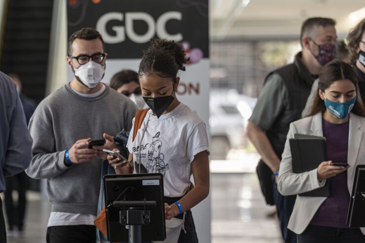 Attendees register inside an exhibition hall during the Game Developers Conference at the Moscone Center in San Francisco, California, U.S., on Tuesday, March 22, 2022. The weeklong video game industry conference is San Francisco's biggest convention since public health orders upended the events business two years ago, reported the San Francisco Chronicle. Photographer: David Paul Morris/Bloomberg