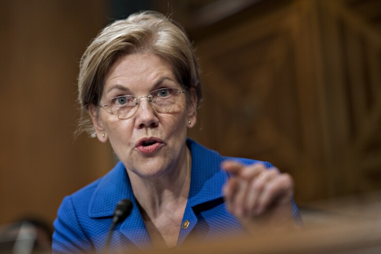 Sen. Elizabeth Warren, D-Mass., questions Jerome Powell, chairman of the Federal Reserve, during a Senate Banking Committee hearing in Washington.