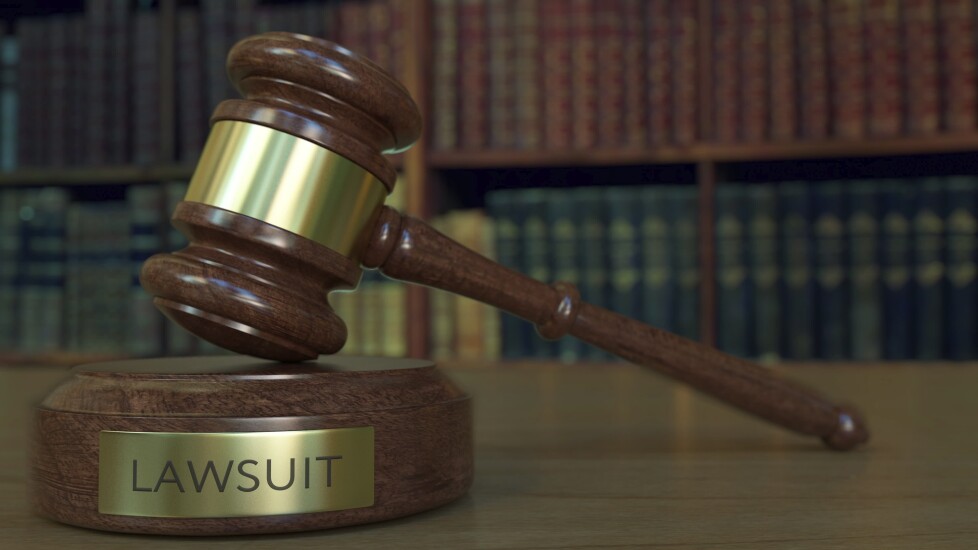 Judge's gavel and block with LAWSUIT inscription