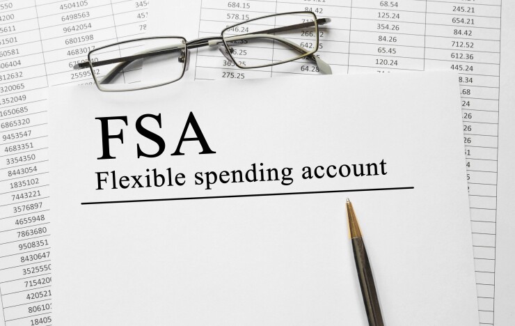 A pair of glasses sits on a spreadsheet titled "FSA Flexible spending account."