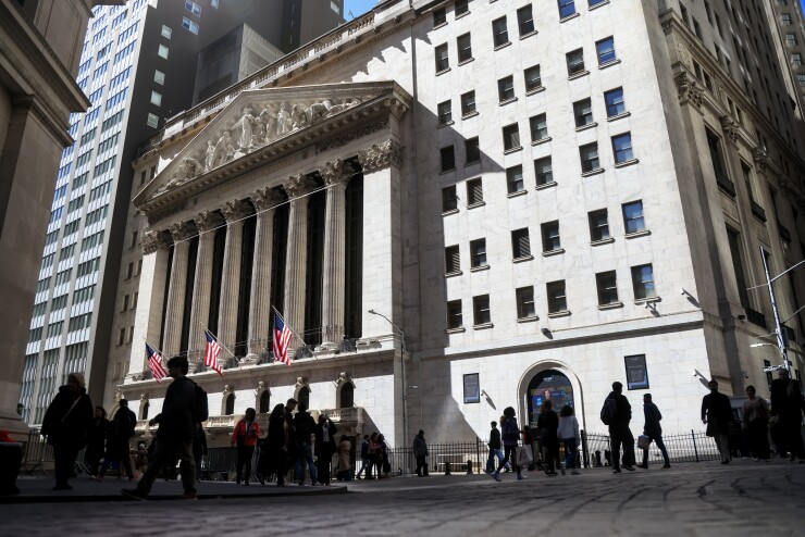 People milling about in a courtyard outside The New York Stock Exchange in New York City.