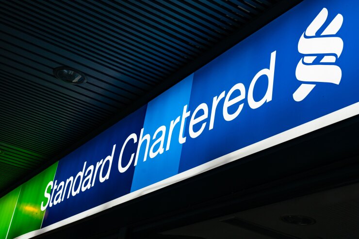 Signage for Standard Chartered is displayed outside a bank branch in Hong Kong.