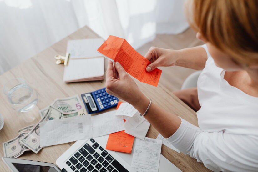 Photo of person holding receipt.