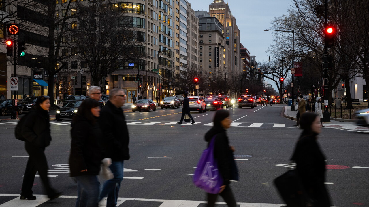 Pedestrians cross a street in Washington, D.C.