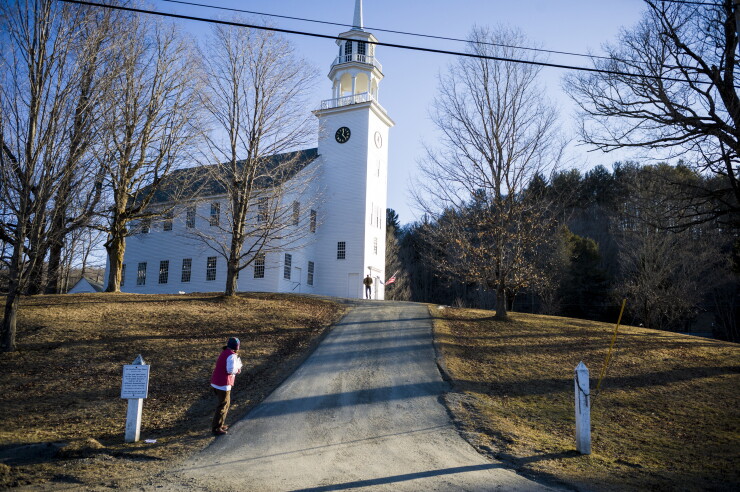 Joie Finely Morris, lower left, asks for signatures to get local politician Matt Dune on the ballot for Vermont governor outside a polling station in Strafford, Vermont, U.S., on Tuesday, March 1, 2016.