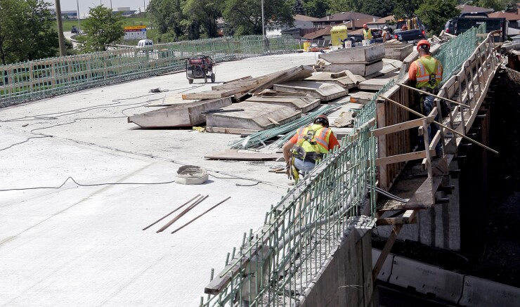 Construction workers build a new overpass along Interstate 294 (I-294) near Chicago, Illinois, U.S., on Monday, June 1, 2009.