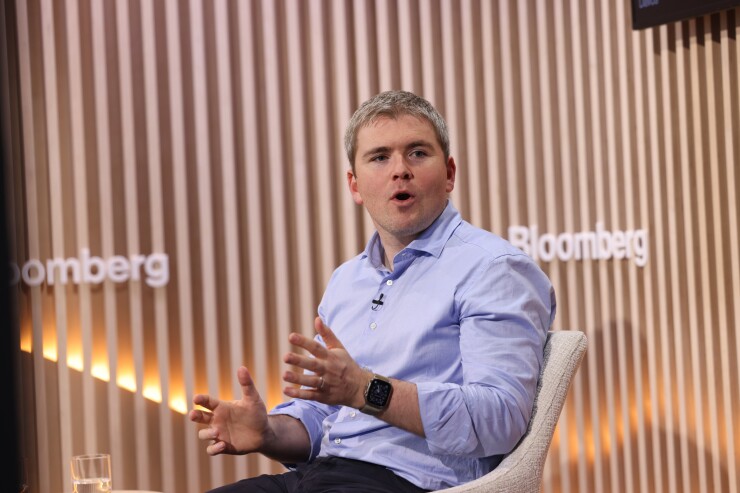 Stripe Co-founder and President John Collison on stage at Davos.