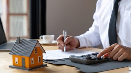 businessmen using a calculator calculating house tax refund on t