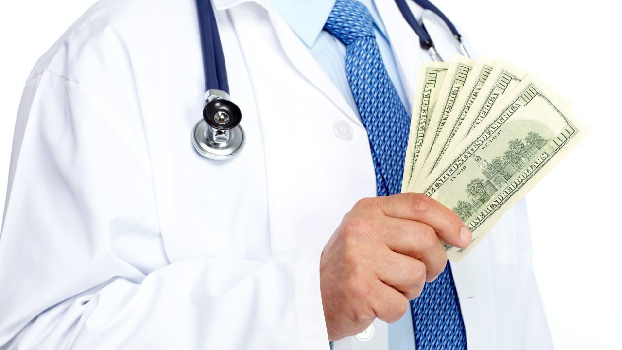 Doctor holding cash