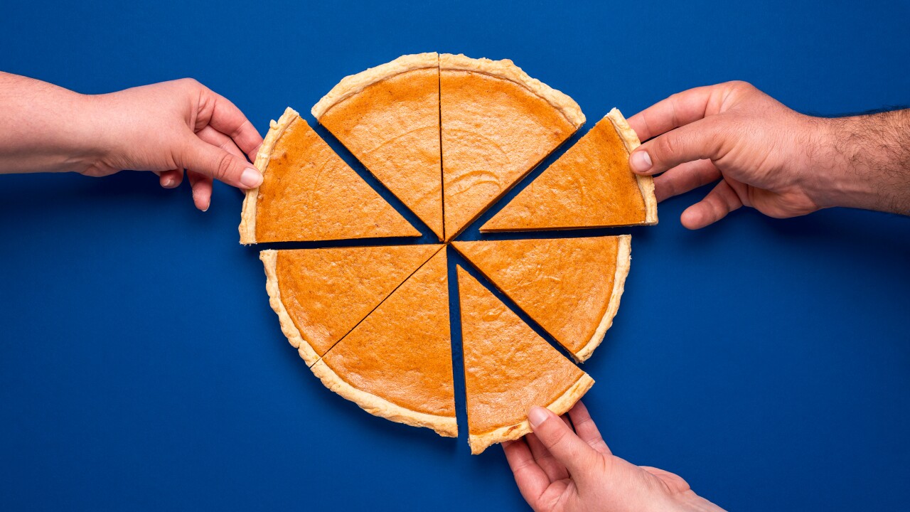Three different hands grabbing slices from a pumpkin pie