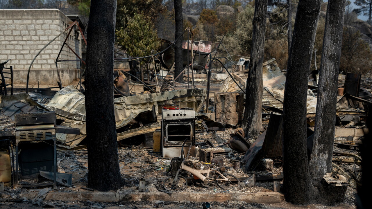 The remains of burned out caravans, ovens and leisure equipment at the Pantano de Burguillo campsite following a wildfire in El Barraco, Spain.