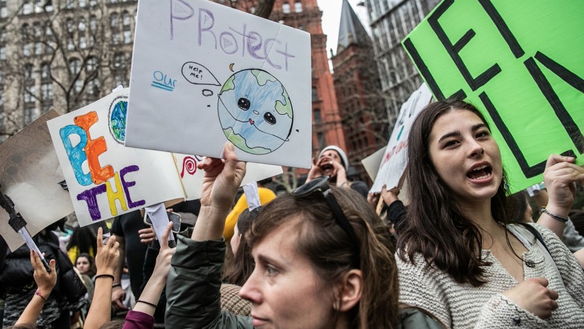 Demonstrators hold signs during the Youth Climate Strike in New York this spring.