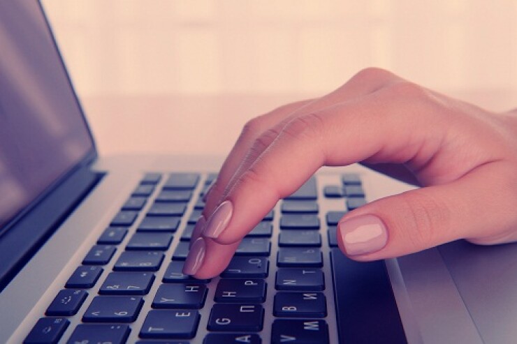 White person's hand using a laptop.