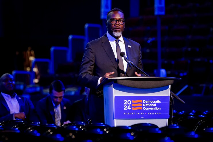 Mayor Brandon Johnson stands at podium