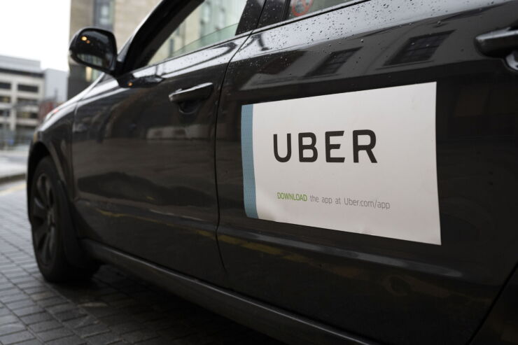 an Uber sticker on the side of a car in Cardiff, Wales.