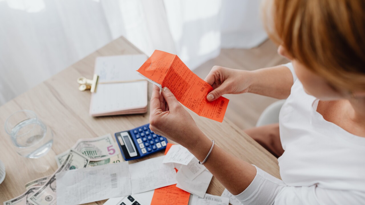 Photo of person holding receipt.