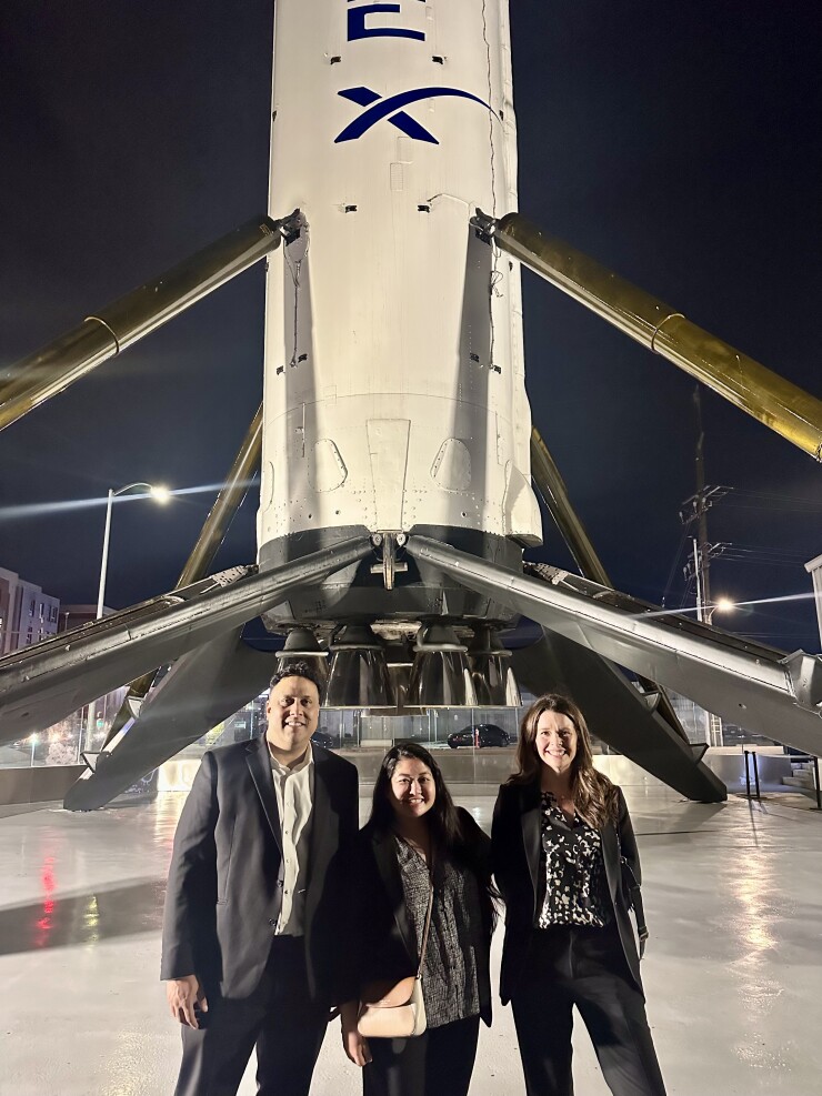 From left to right, Palash Islam, Lindsey Ahlo and Shannon Irwin of California-based registered investment advisory firm Synergy Financial Group posed at the SpaceX headquarters in Hawthorne after a client meeting last month.