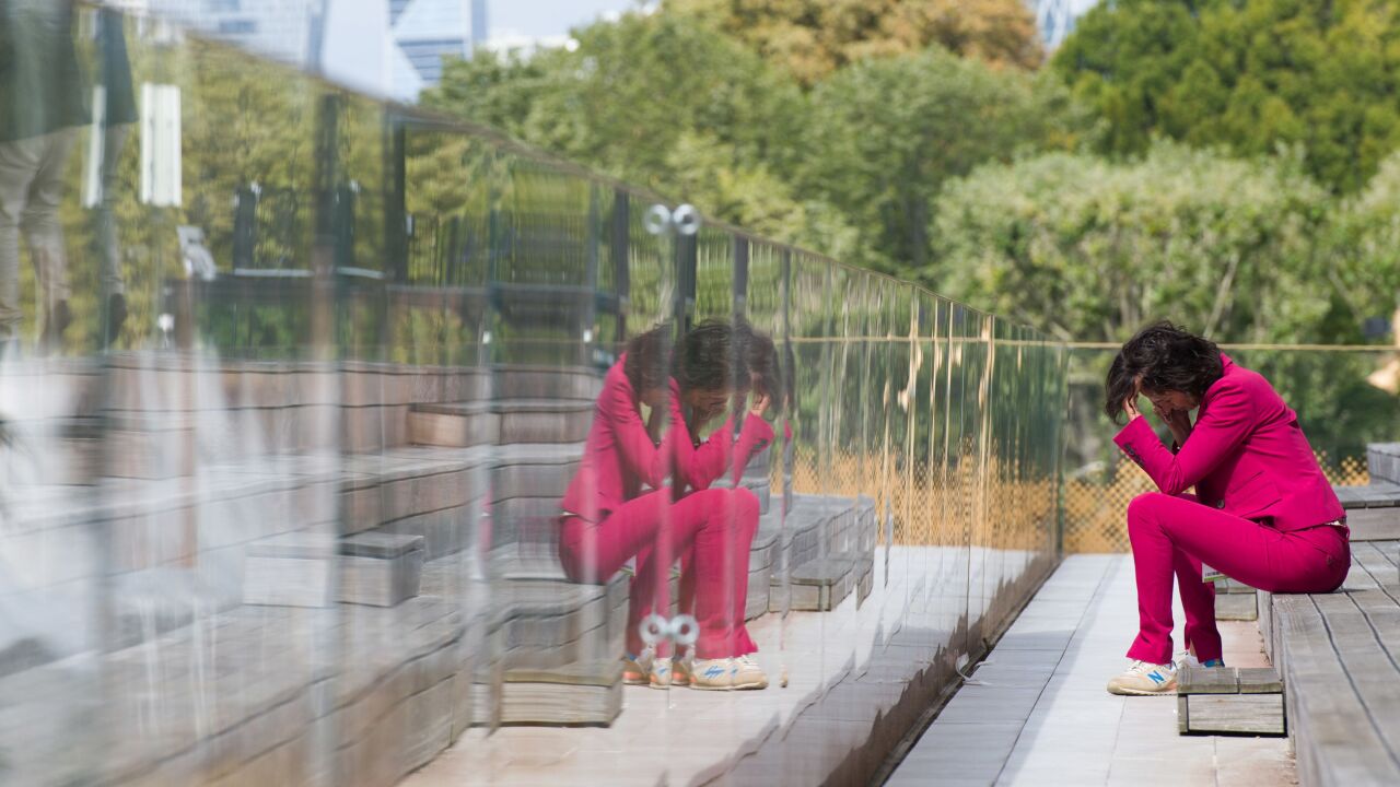 An attendee makes a phone call during the Mouvement des entreprises de France (MEDEF) business conference at Longchamp racecourse in Paris, France, on Thursday, Aug. 19, 2021. French economic policy should shift to address the challenges of the climate transition for industry and employment, and focus less on the Covid-19 pandemic, the chief economist of the country’s treasury said. Photographer: Nathan Laine/Bloomberg