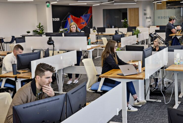 Employees work at the Strider Technologies headquarters in South Jordan, Utah, US, on Friday, Jan. 7, 2022. Strider Technologies scours open-source data in China to identify technologies most at risk of being stolen — and the people who might be tempted to steal them. Photographer: Kim Raff/Bloomberg
