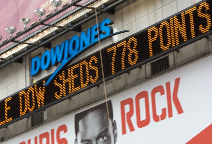 The Dow Jones ticker in Times Square displays news about the stock market on Sept. 29, 2008, as U.S. stocks plunged and the Standard & Poor's 500 Index tumbled the most since the 1987 crash.