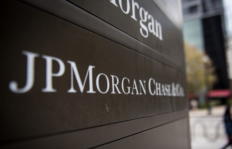 Signage stands on display outside the JPMorgan & Chase Tower in downtown Chicago, Illinois, U.S., on Saturday, Oct. 7, 2017. AKA J.P. Morgan.