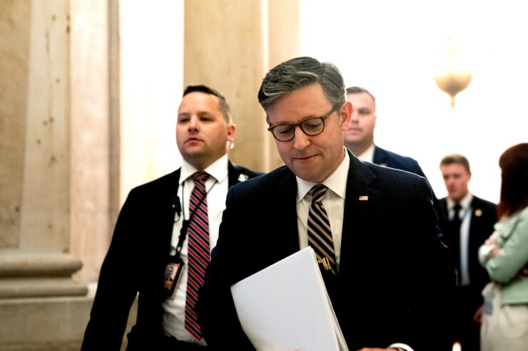House Speaker Mike Johnson walking with head down