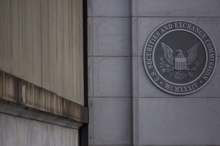 Signage is displayed outside the headquarters building of the U.S. Securities and Exchange Commission (SEC) in Washington, D.C., U.S., on Dec. 22, 2018. Parts of the U.S. government shut down on Saturday for the third time this year after a bipartisan spending deal collapsed over President Donald Trump's demands for more money to build a wall along the U.S.-Mexico border. Photographer: Zach Gibson/Bloomberg