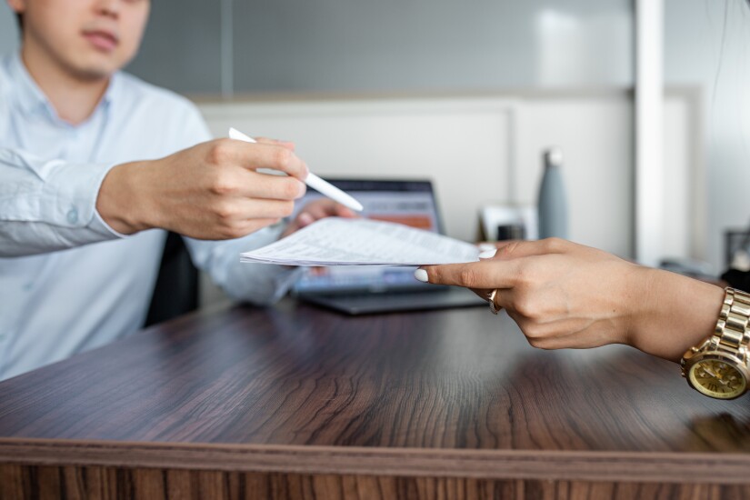 business meeting. business partners sign papers and hand over documents