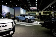 General Motors' booth at the 2025 Detroit Auto Show, featuring a blue pickup truck.
