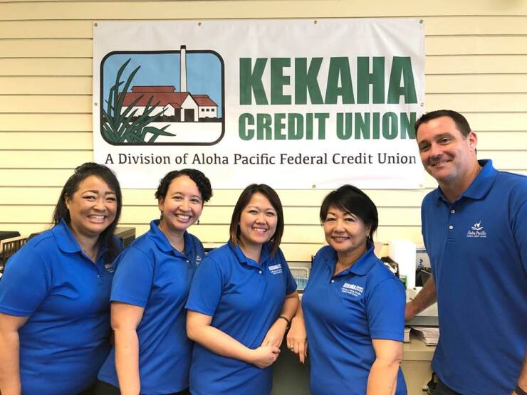 Staffers of Aloha Pacific Federal Credit Union and the former Kekeha CU pose on their first day working together after the two CUs merged.