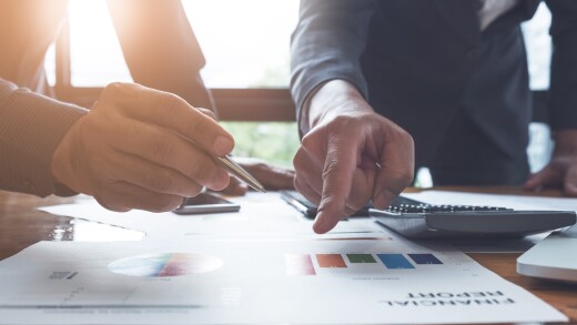 young business man and partner pointing on financial report for analyze the company's sales plan in the office...