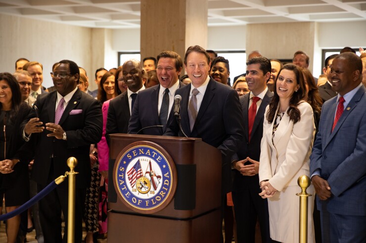 Florida Gov. Ron Desantis (left) and Senate President Bill Galvano take the podium after lawmakers pass the state budget on May 4, 2019.
