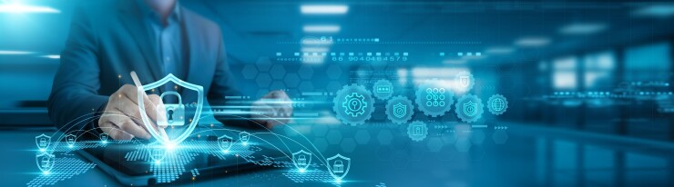 Businessman analyzing cybersecurity trends and threat detection graphs on office table