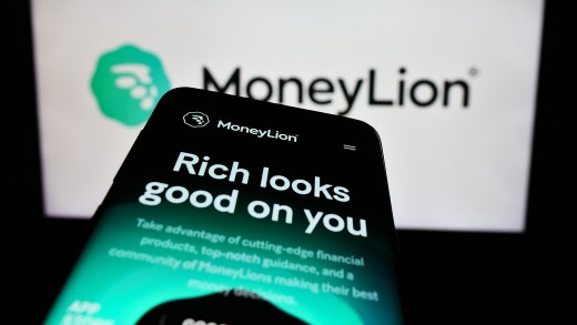Stuttgart, Germany - 02-03-2024: Smartphone with website of US financial technology company MoneyLion Inc. in front of business logo. Focus on top-left of phone display.