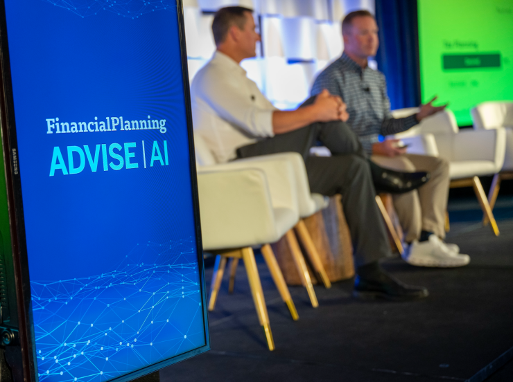 The state at an ADVISE AI event with a logo and two men speaking to an audience.